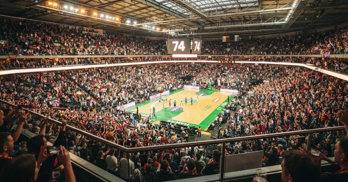 Un pabellón deportivo lleno bajo los focos, fotografiado desde muy lejos